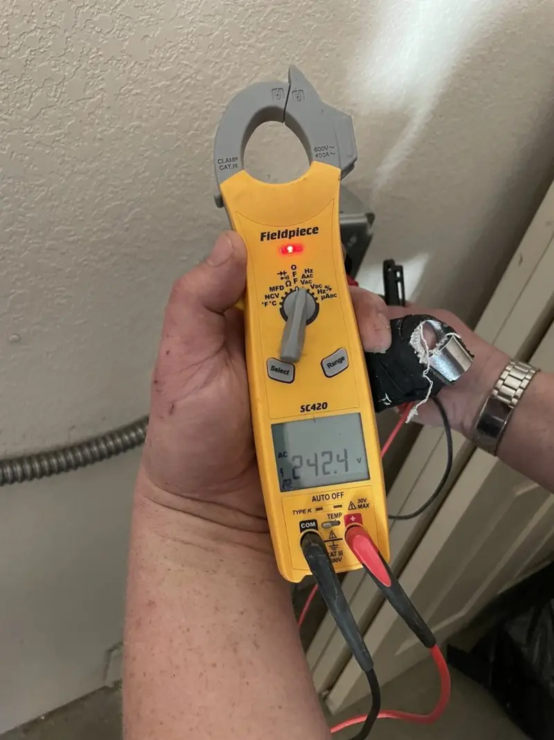 Voltage testing with clamp meter during Outlet Installation in Gonzales